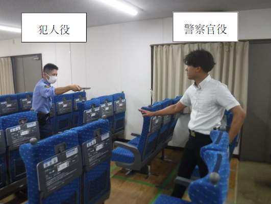 写真：犯人役と対峙する警察官