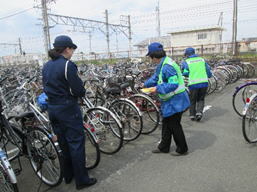 写真：駐輪場にて自転車盗難防止活動をする地域安全推進員たち