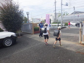 写真:地域安全推進員、ボランティアに見守られて下校する小学生たち