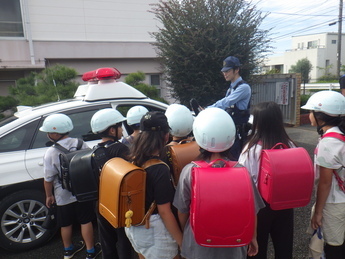 写真:警察官の話を聞く小学生たち